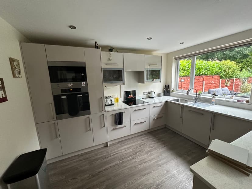 Kitchen before respray - white builder grade kitchen in Urmston