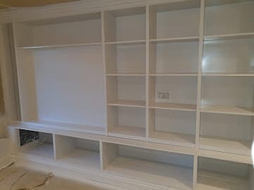 Built-in shelving after - professional white paint finish