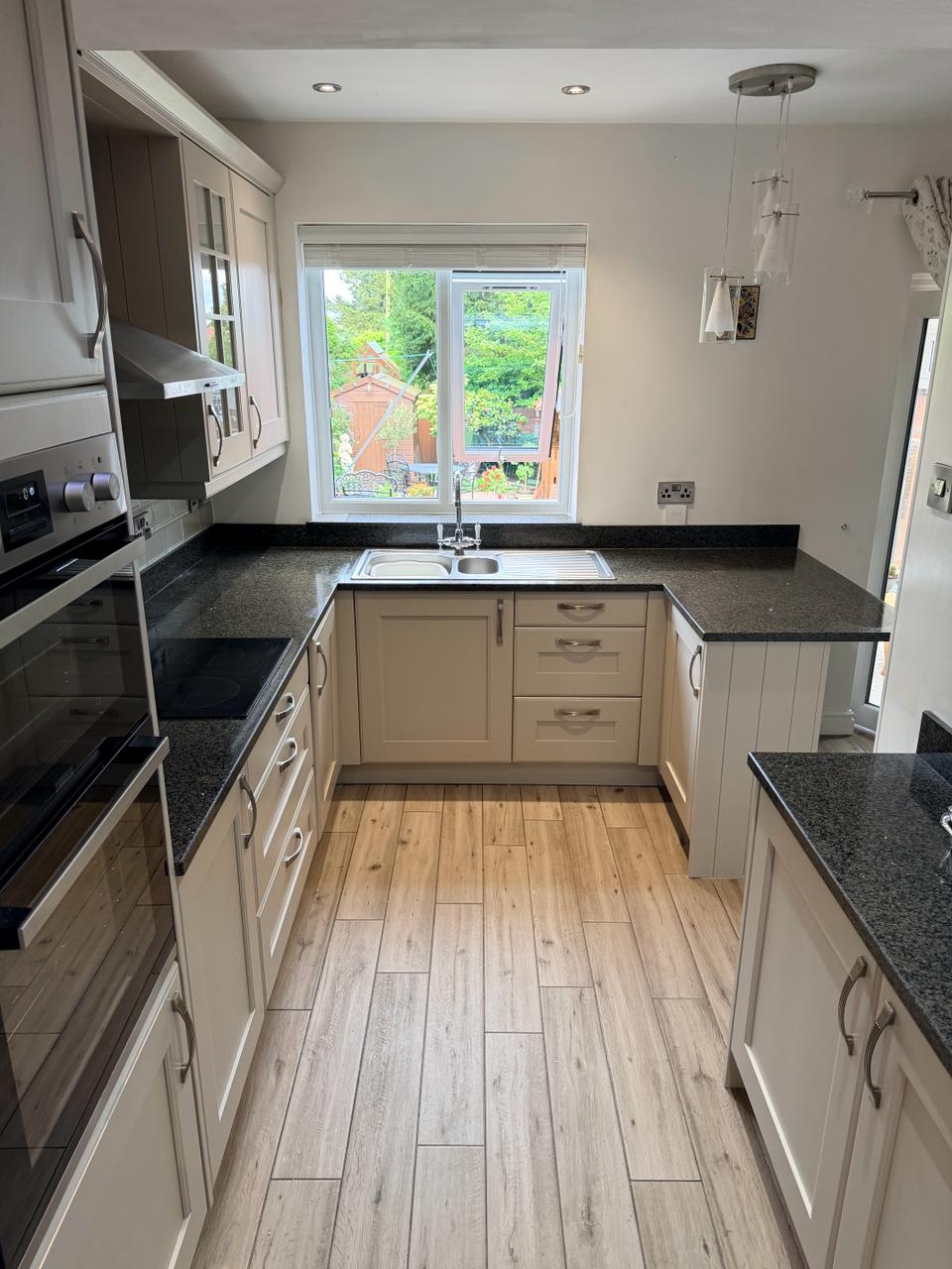 After kitchen respray showing the same kitchen professionally refinished in a light colour